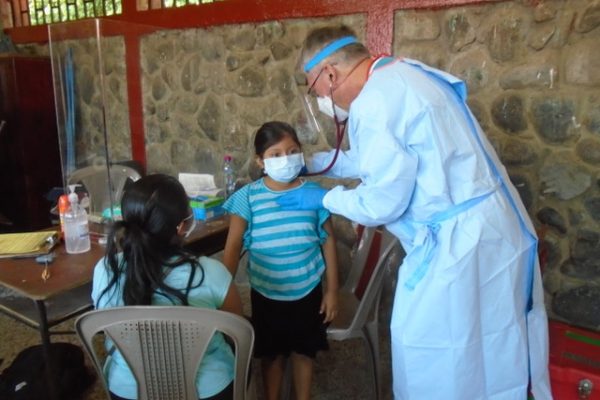 Dr. Dimmick, Pediatrician, examines  a young girl