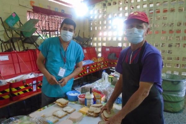 Hector, an employee of Faith In Practice for twenty four years, serving in multiple capacities, 
Today prepares lunch with Sarbelio, a local volunteer Red Hat