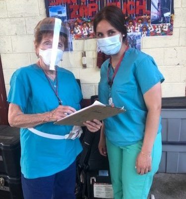 Faith In Practice founder, Vera Wiatt, with Daniela, Casa de Fe Coordinator, preparing for patient triage